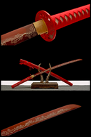 Handmade red katana with T10 steel blade featuring intricate patterns and red handle, displayed on a wooden stand.