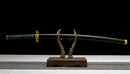 Muichiro Tokito sword replica on display stand, featuring sleek black scabbard and intricate handle design.
